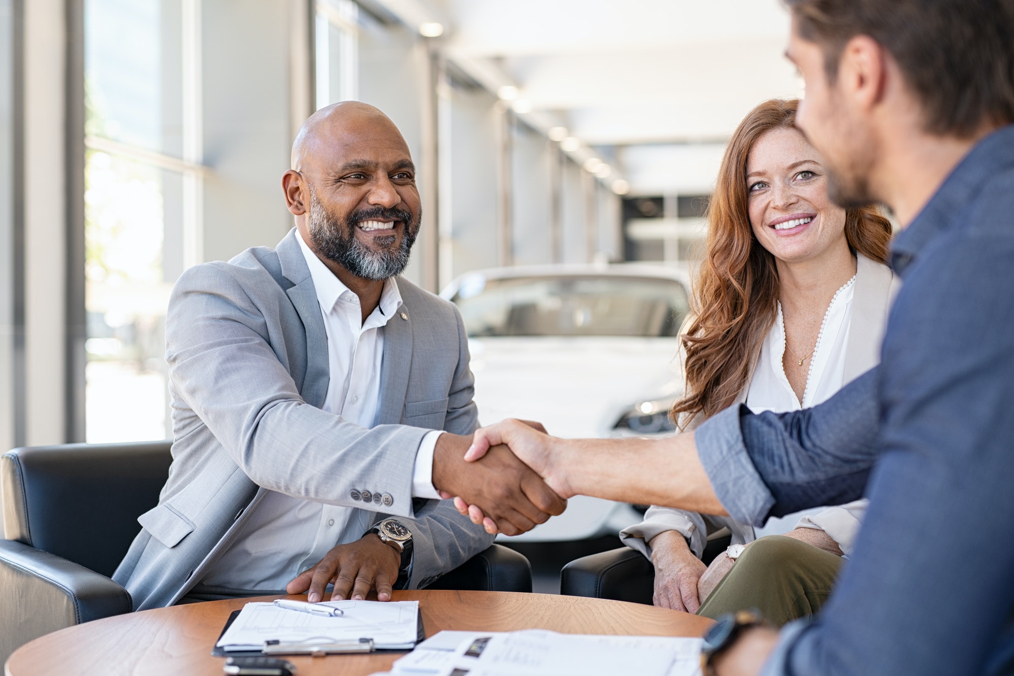 Couple buying new car at car dealership